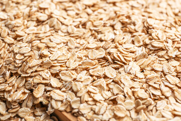 Heap of raw oatmeal as background, closeup