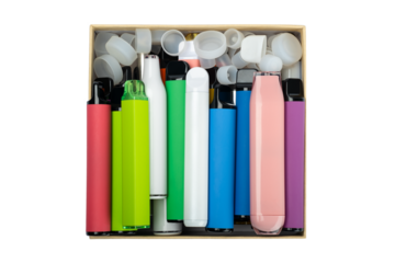 Synthetic nicotine concept. Various disposable electronic cigarettes in cardboard box. modern alternative smoking, vaping and nicotine.