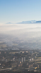 Obraz premium view of city of Oviedo from the air and below mountains and clouds