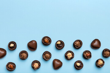Different kinds of chocolates on colored table close-up. Top View and Flat Lay with copy space