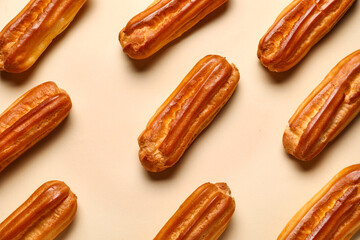 Tasty sweet eclairs on color background