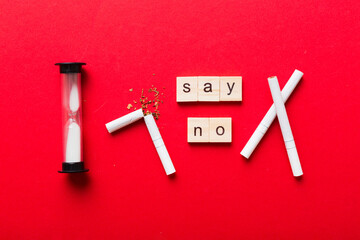 Cigarette And Wooden Blocks, Broken cigarette on table background with hourglass, No Tobacco Day...