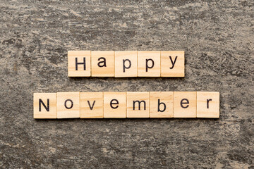 Fototapeta premium Happy november word written on wood block. Happy november text on table, concept