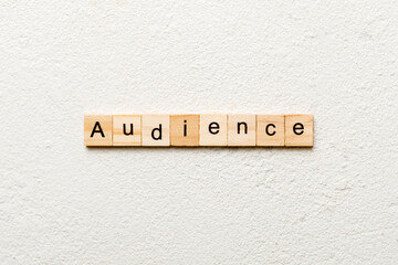 AUDIENCE word written on wood block. AUDIENCE text on cement table for your desing, concept