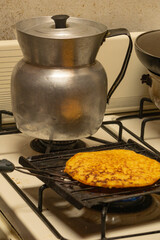 roasting a corn arepa