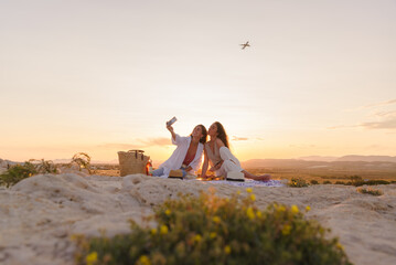 Couple of young women on vacation watch the sunset