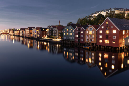 Colorful houses during blue hour along Nidelva River in Trondhei