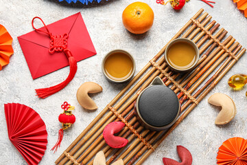 Fortune cookies with teapot, cups and Chinese symbols on grunge background. New Year celebration