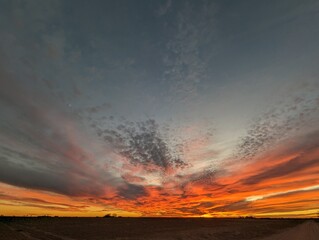 fire in the sky; fire orange sunset in west texas; wide landscape sunset and cloudscape
