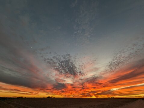 fire in the sky; fire orange sunset in west texas; wide landscape sunset and cloudscape