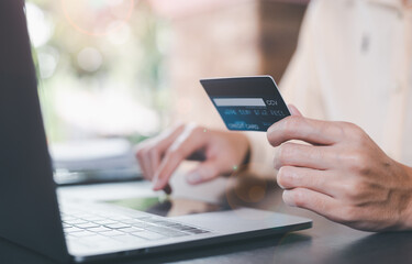 Consumers use credit cards to conduct financial transactions via the Internet,payment concept with wireless communication technology,ecommerce, digital banking and online payment concept