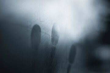 Close-up of fingerprints on condensed glass window