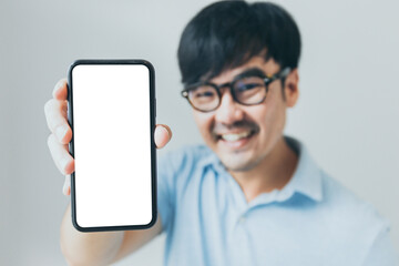 cell phone blank white screen mockup.hand holding texting using mobile on desk at office.background...