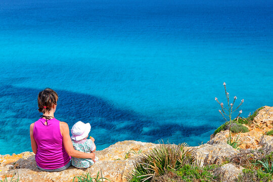 Woman with her daughter hiking in Cala Mesquida on the island of Mallorca.