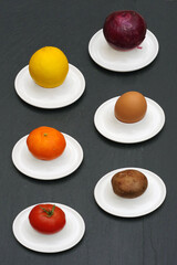 Foods on white porcelain egg cup plates