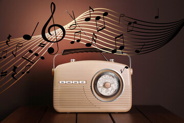 Staff with music notes and other musical symbols flowing over retro radio on brown background