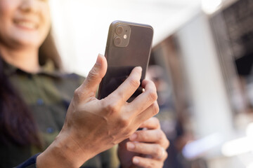 woman using cell phone hand holding mobile texting message contact us.chatting,search internet information.technology device communication connecting