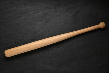 Baseball bat on black background, top view. Sports equipment