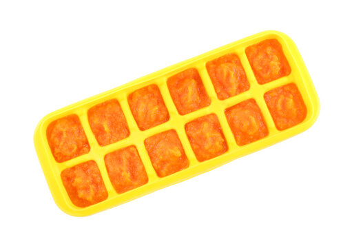Puree in ice cube tray on white background, top view. Ready for freezing