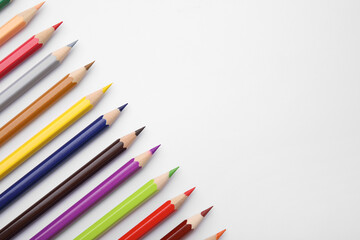 Colorful wooden pencils on white background, flat lay. Space for text