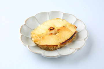 On a white background, a round plate was placed with grilled melo.