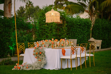 Banquet table near chandelier with light on