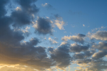 Summer evening sky in the picturesque clouds, lit by the rays of the setting sun.