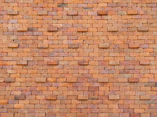 Fototapeta premium The ancient red brick wall stood tall and imposing, its intricate details and wear adding to its rugged charm. The wall stretched on for what seemed like an eternity