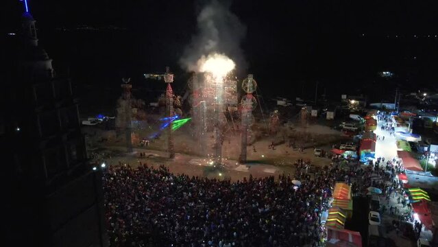 aerial shot of happy new year with big party in Mexico city with bright fireworks at night in a metallic structure