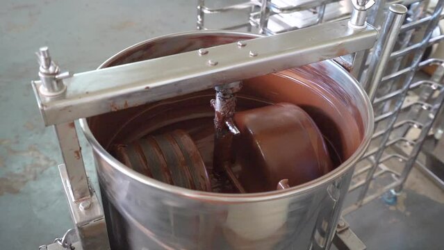Chocolate In A Melanger During Conching Process In Factory. closeup