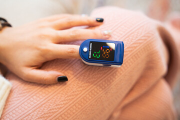 Close up Finger of patient watching and Checking blood oxygen