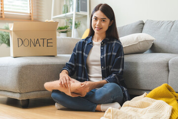 Recycling, Donation for poor, asian young woman, girl sitting pack object at home, putting on stuff...