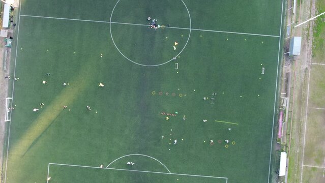 top down aerial view of a football training session in the Buenos Aires club at sunset