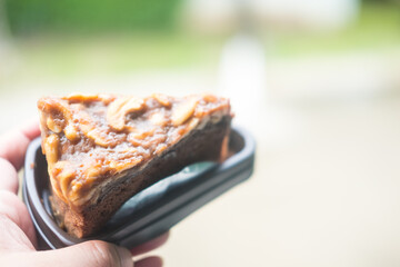 Chocolate cake brownies with cashew nuts on top in a brown plastic pack for send to the customer