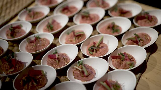 Fruit and foie gras appetizer plates on tray, Close up handheld shot