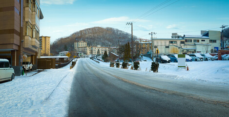 Empty road with beautiful winter small town