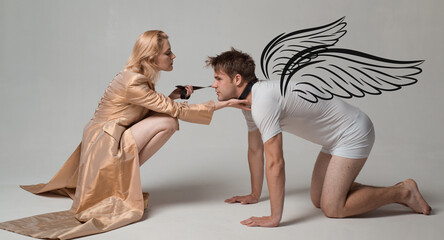 Angels couple, valentines day photo banner. Dominatrix blonde woman holding her husband in collar and make him obey. Loving couple play in love sex games.