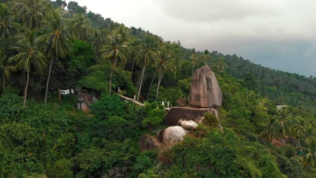 A bridge to a huge stone with a name Overlap Stone viewpoint on the Lamai Beach in Samui, Thailand. Aerial shot forward fly. High quality 4k footage