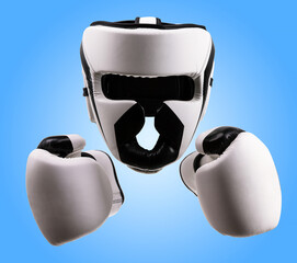 Boxing helmet and gloves isolated over blue background, with clipping path. Sport goods, defense...