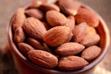 Roasted almonds in a ceramic cup.Warm tone image.