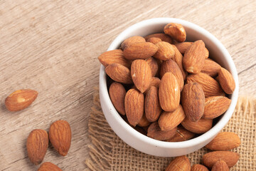 Salted almonds in a white cup.Copy space.