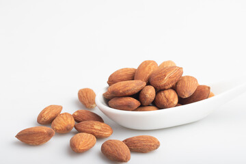 Salted almonds in a white cup.Copy space.