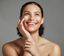 Skincare, face beauty and woman with cream for acne, dermatology and glow on a studio background....