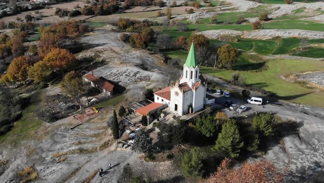 Aerial: flying over a chappel in the catalan countryside in Spain. Circular shot