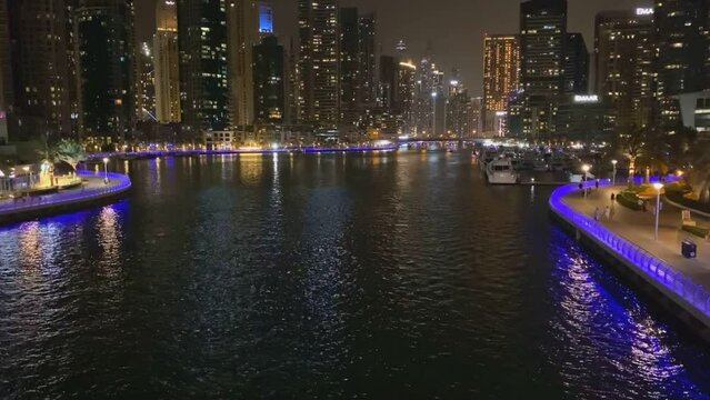Dubai night time lapse from Dubai Marina skyscrapers jogging and water