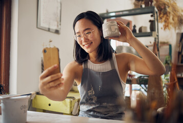 Artist woman, pottery and selfie with smile, design and product in studio to sell on internet, app or social media. Asian art girl, sculpture and smartphone with happiness, vision and artwork at desk