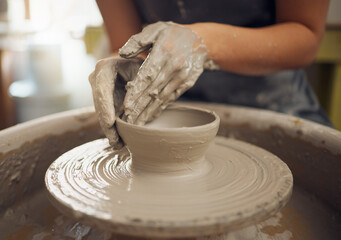 Hands, clay and pottery with a woman designer working in a studio or workshop for art, design and ceramics. Creative, sculpture and wheel with a female artist at work as a potter or ceramic artisan - obrazy, fototapety, plakaty