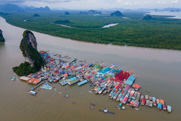 Aerial view over the floating fishing village at Ko Panyi (or Koh Panyee) one of famous travel destination in Phang Nga Bay, Phang Nga province, Thailand. © Summer Paradive