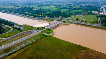 Naklejka premium Aerial view over Pasak Chonlasit Dam or Pa Sak Jolasid Dam, located between Lopburi province and Saraburi province, Thailand. Renewable energy and hydroelectric generation.