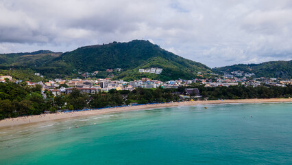 Fototapeta na wymiar Aerial tropical landscape of Kata Beach and Andaman sea. Drone view over the coastline of Phuket city, a famous travel destination in the South of Thailand.